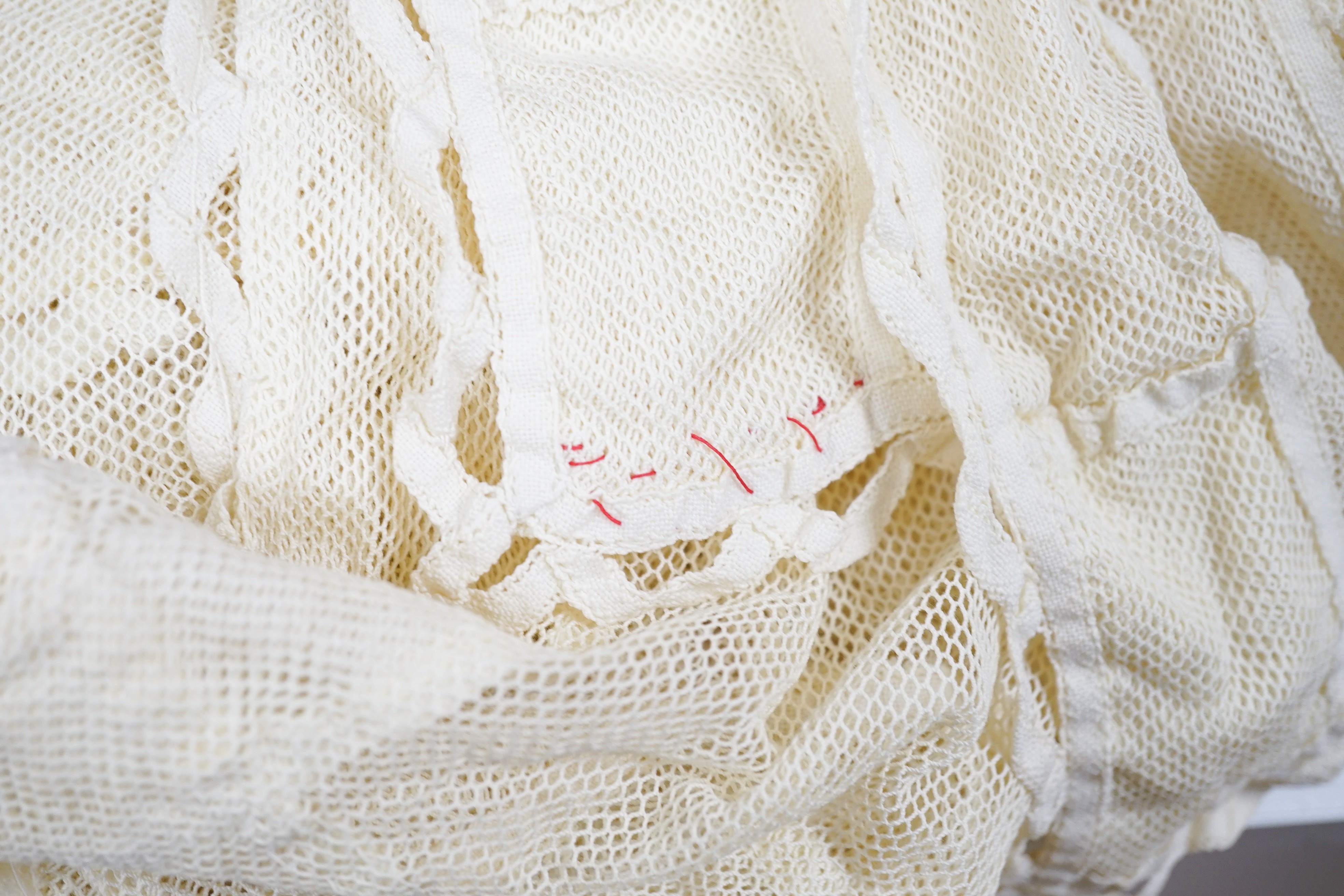 A cream tape vale on net bed cover, approximately 264 x 210cm